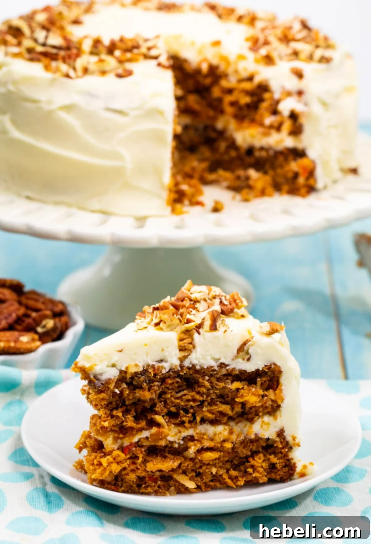 Single slice of Easy Carrot Cake on a white plate, showcasing the thick cream cheese frosting.