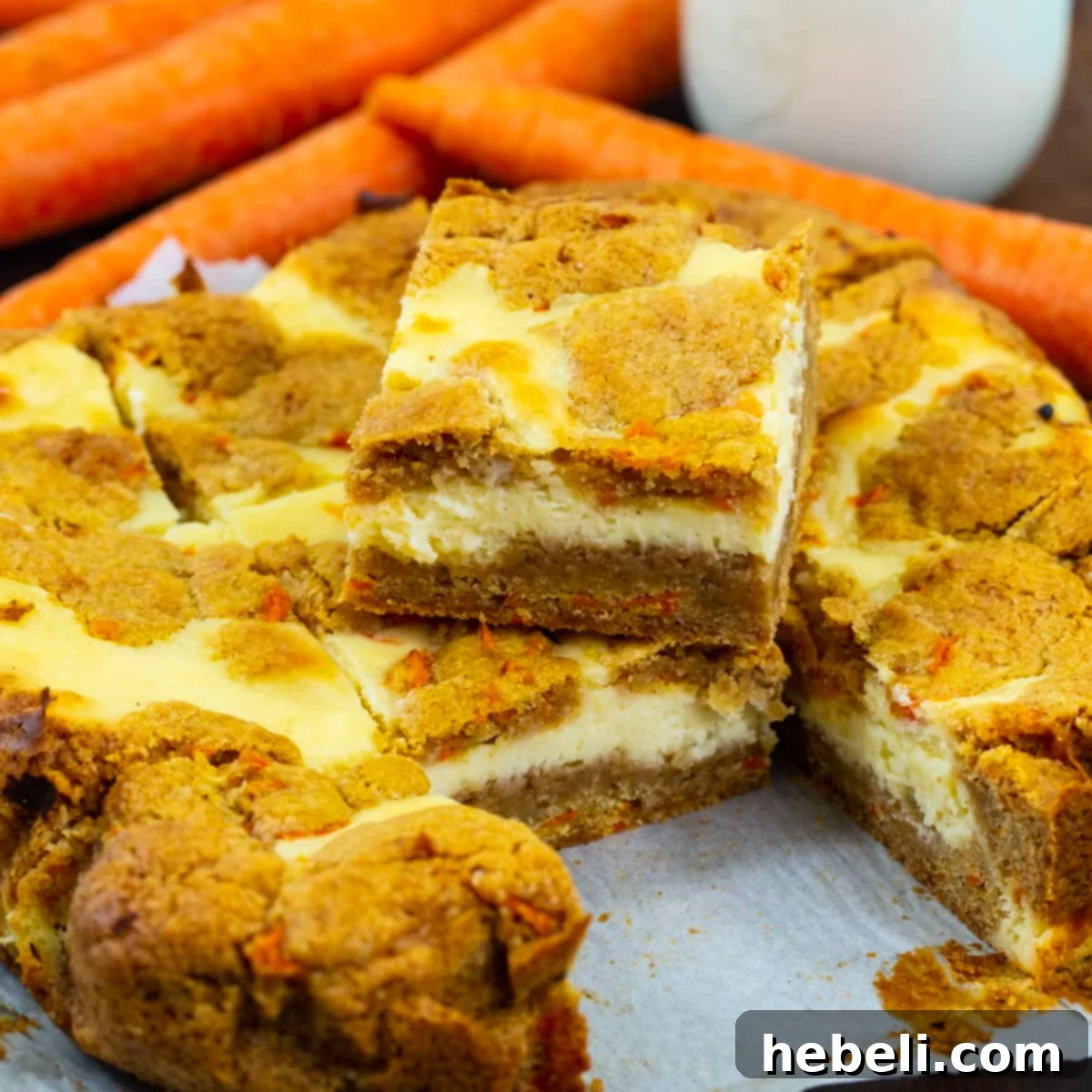 Spiced Carrot Cake Cheesecake Bars 2 Carrot Cake Cheesecake Bars cut into perfect squares, showcasing the distinct layers of spiced cake and creamy cheesecake.