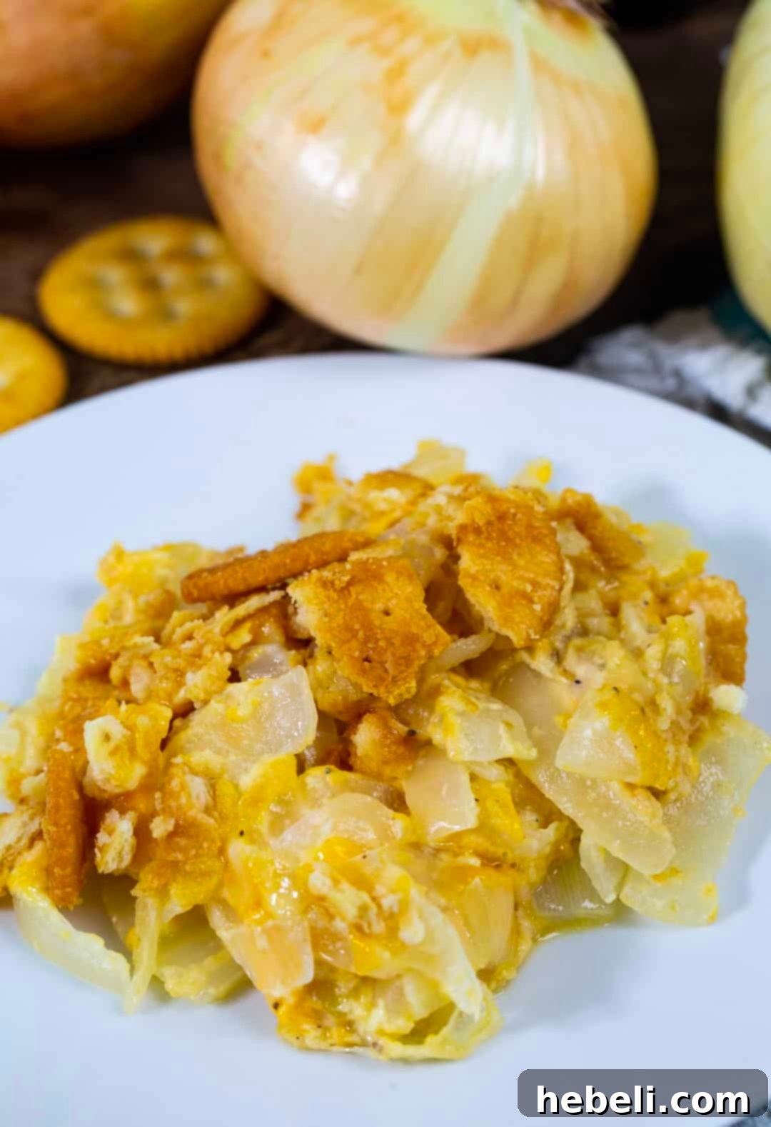 Vidalia Onion Casserole dished up on a plate with other meal components.