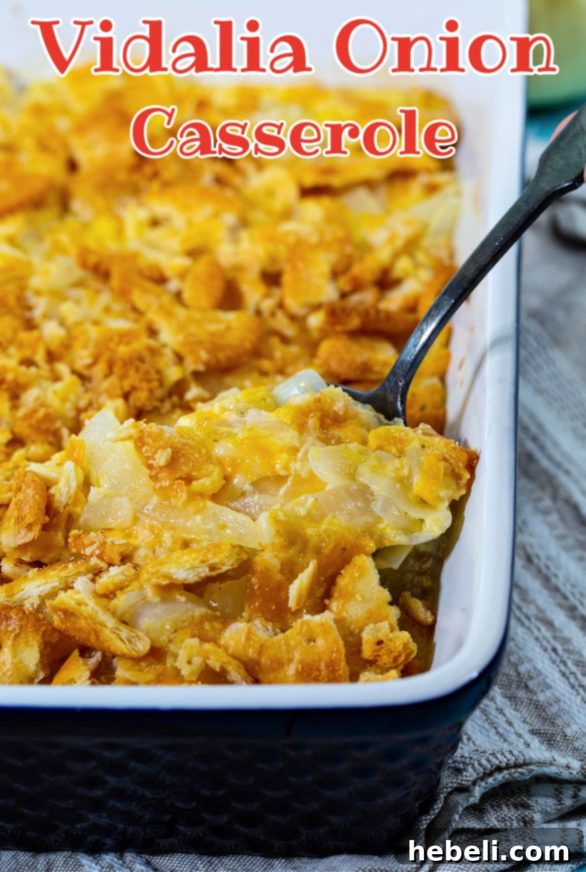 Spoon scooping up Vidalia Onion Casserole, close up on creamy texture.