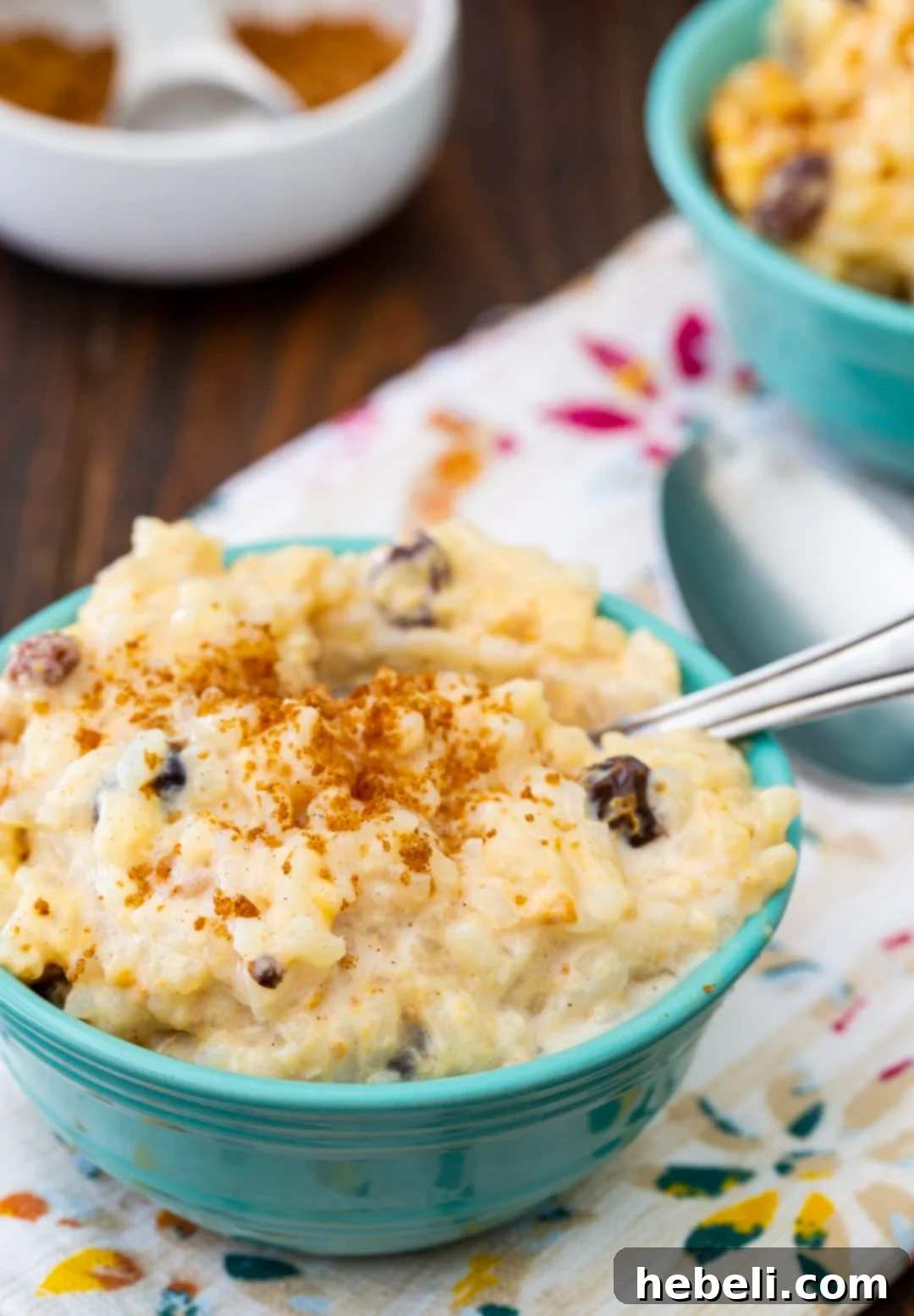 A generous serving of creamy Slow Cooker Rice Pudding in a bowl, garnished for enjoyment.