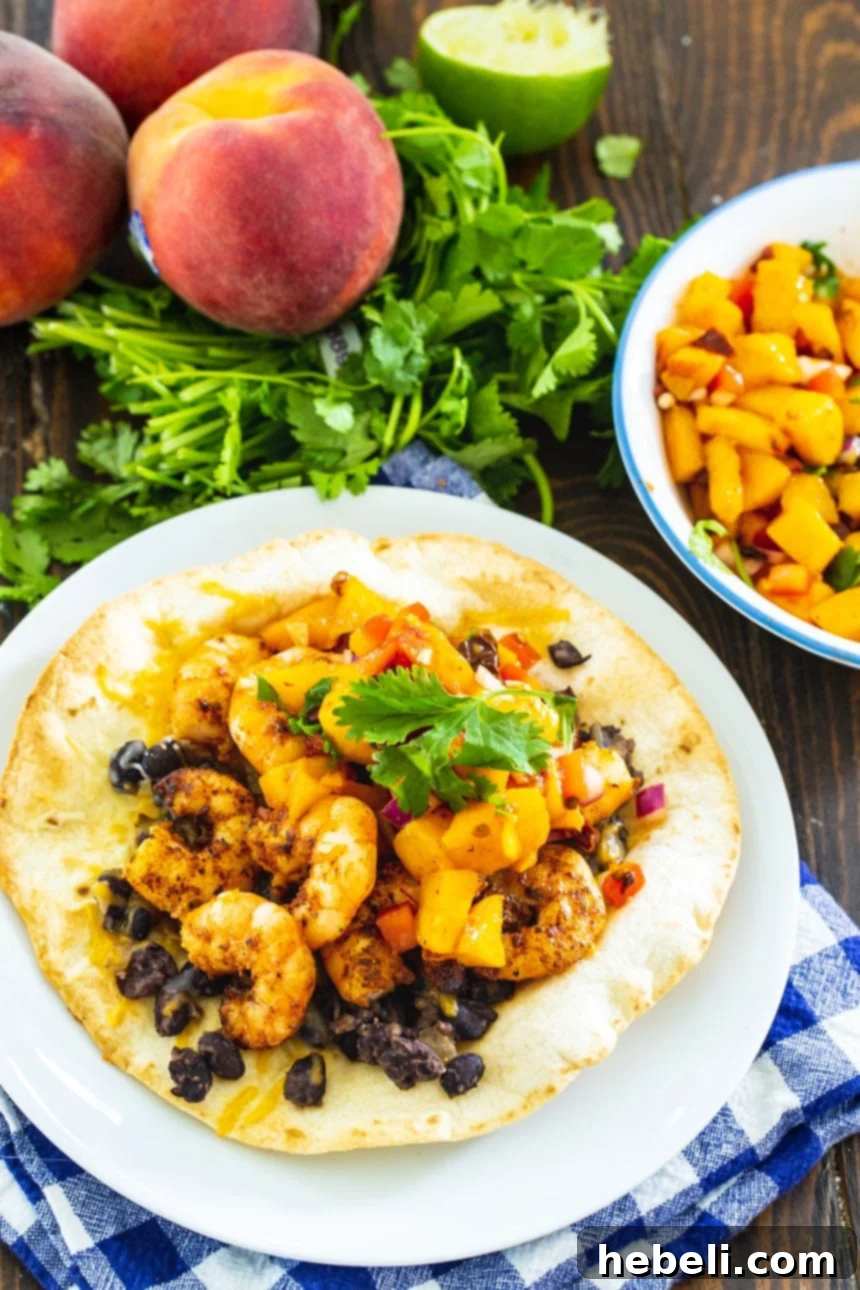 Sweet Peach Shrimp Tostadas 3 Shrimp Tostada presented alongside fresh peaches and cilantro, highlighting the vibrant ingredients.