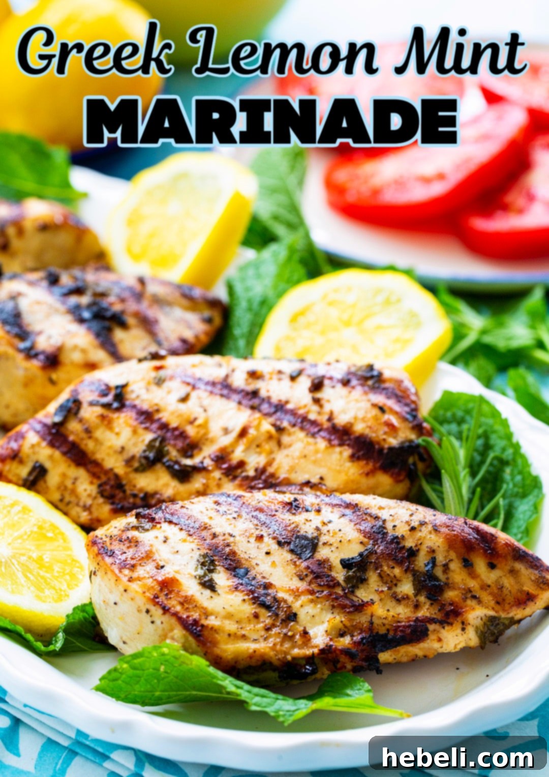 Another perspective of grilled Greek Lemon Mint Marinade chicken on a plate, with a focus on its perfectly charred exterior.