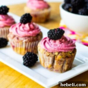 Blackberry cupcakes on a rectangular serving platter.