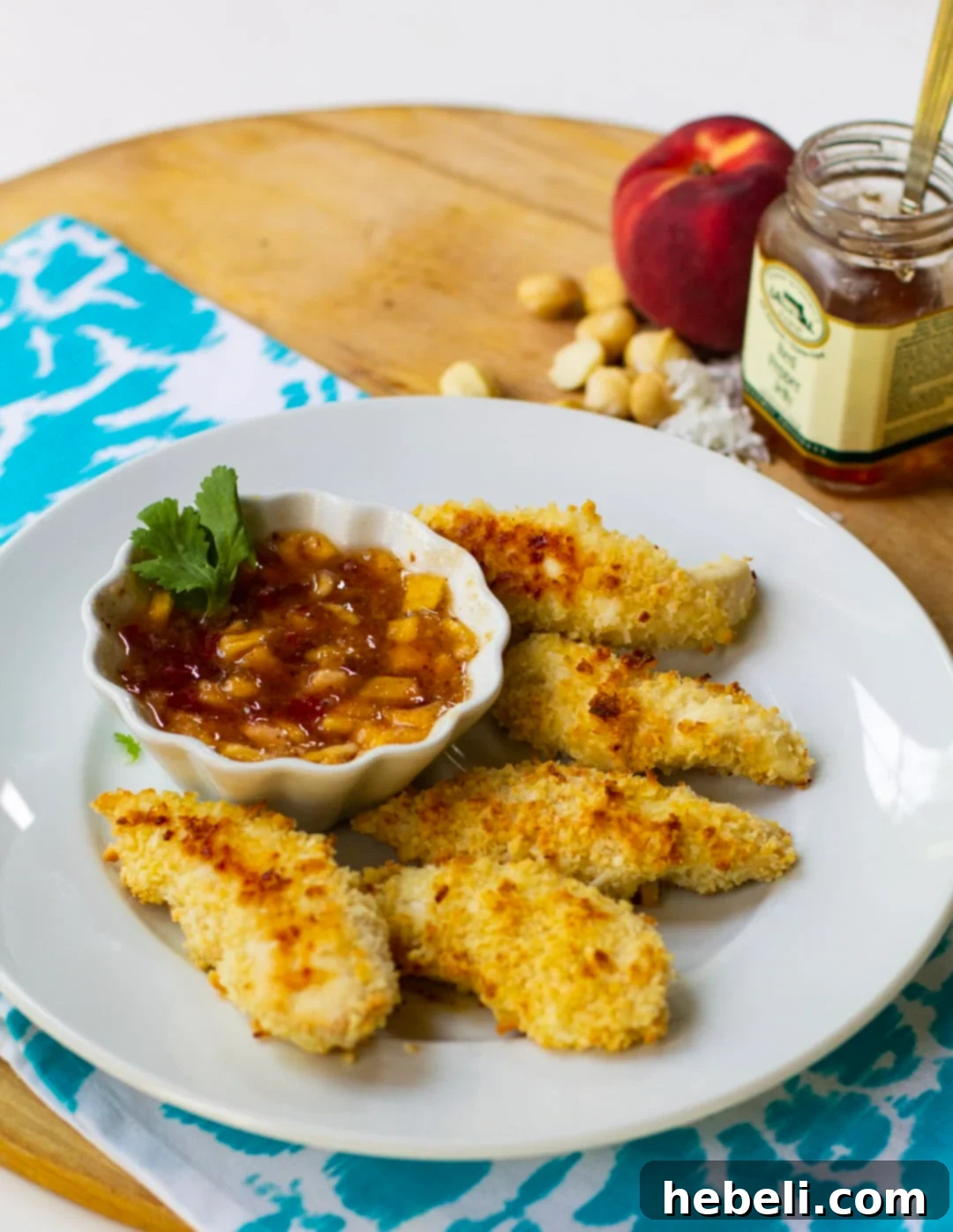 Tropical Macadamia Coconut Chicken Tenders 3 Close-up shot of crispy Coconut Macadamia Chicken Tenders on a plate, highlighting the textured, golden-brown coating.