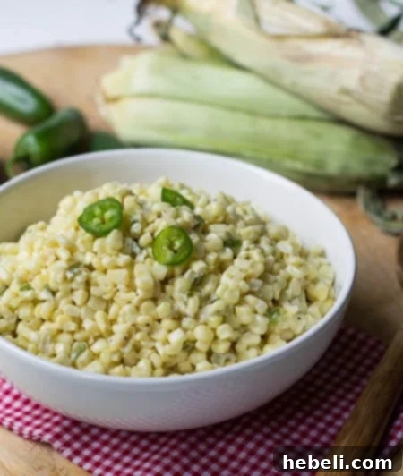 Kickin Jalapeno Creamed Corn 4 Jalapeno Creamed Corn in serving bowl with corn on the cob in background.
