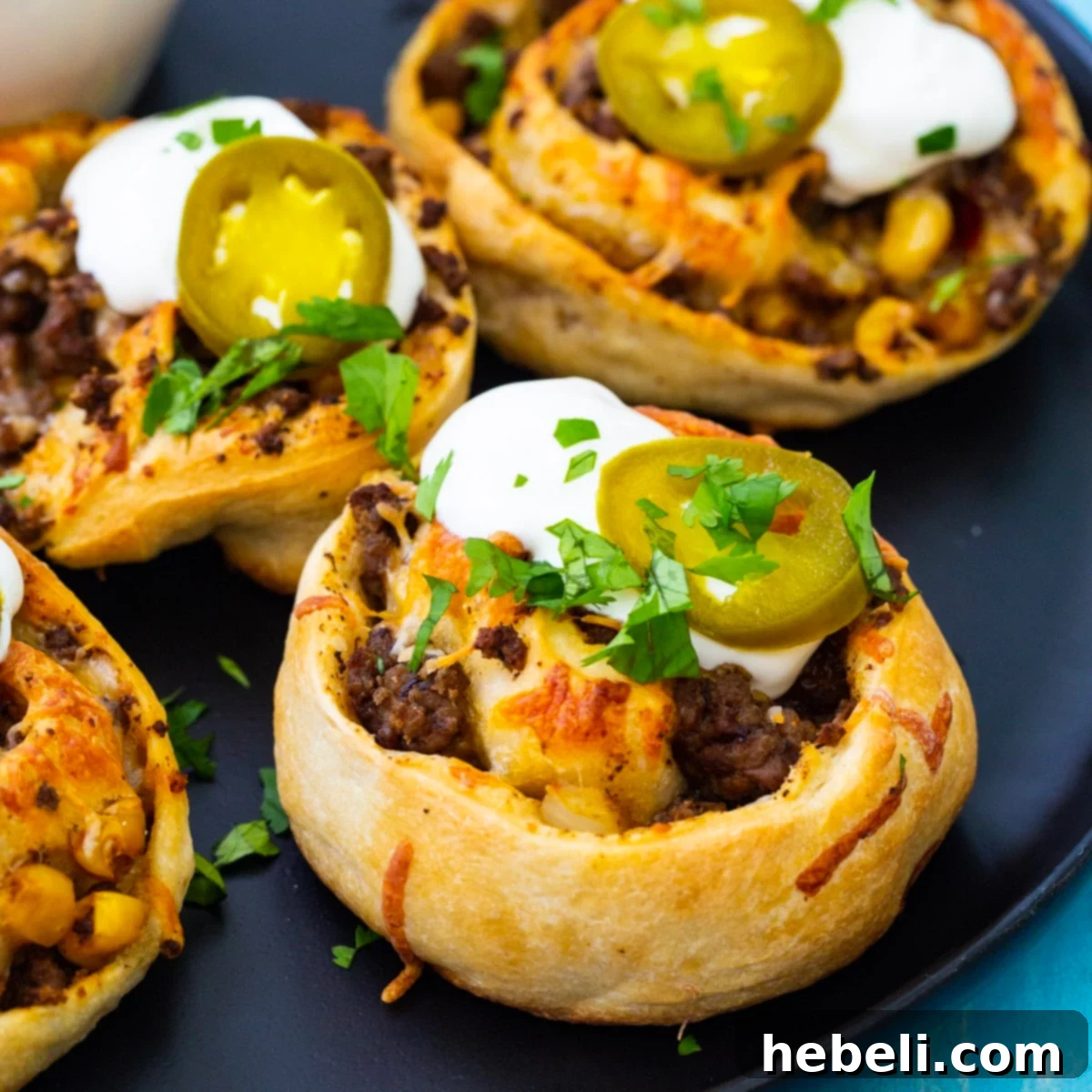 Fiesta Pizza Rolls 2 Delicious Taco Pizza Rolls perfectly arranged on a serving plate, ready to be enjoyed.