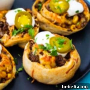 Fiesta Pizza Rolls 8 A plate of golden brown Taco Pizza Rolls with a side of sour cream and cilantro for garnish.