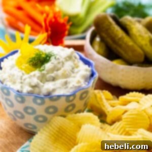A small bowl of fresh Dill Pickle Dip, ready to be served, showcasing its light green color and creamy texture.