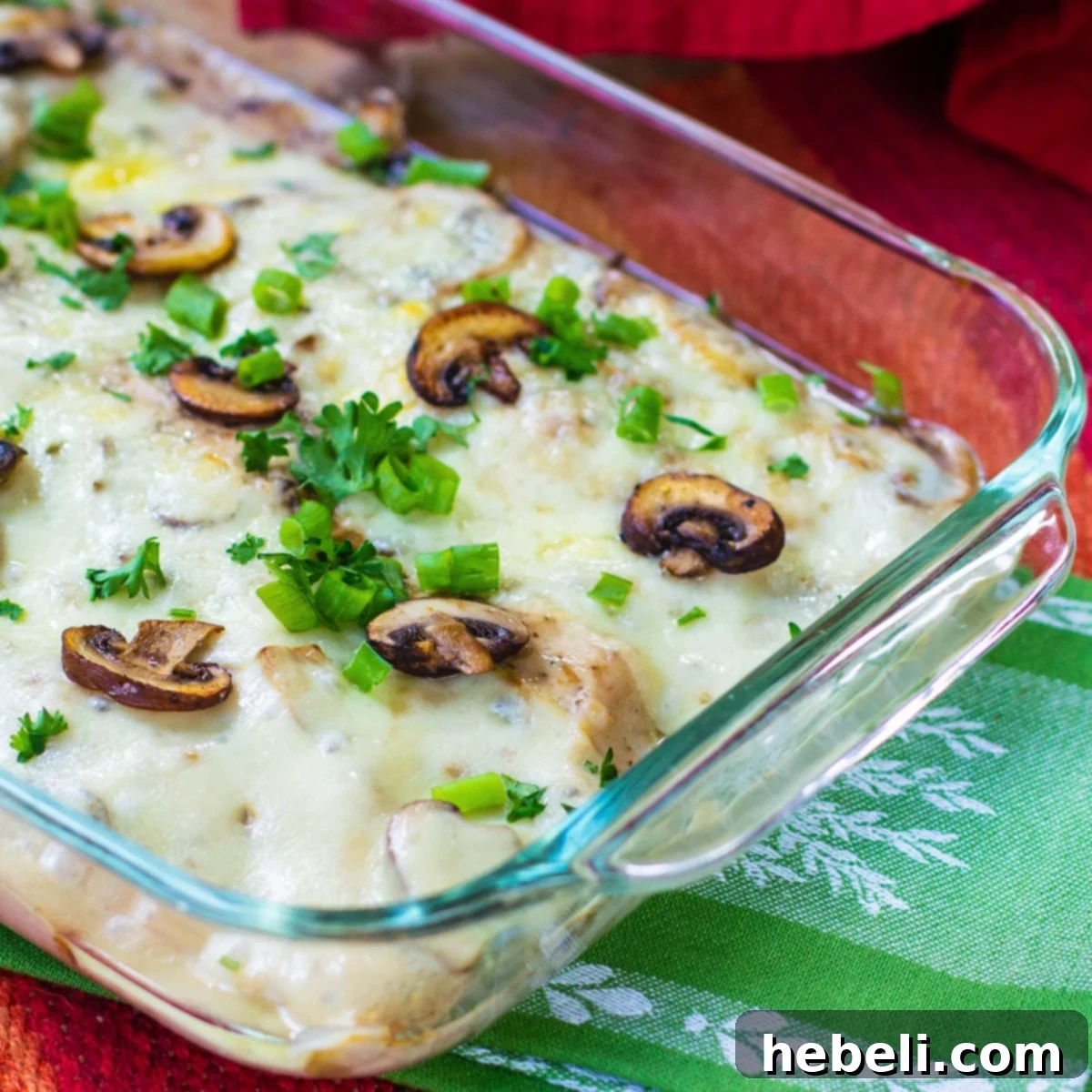 Sherried Chicken with Mushrooms in a glass baking dish, rich and creamy.