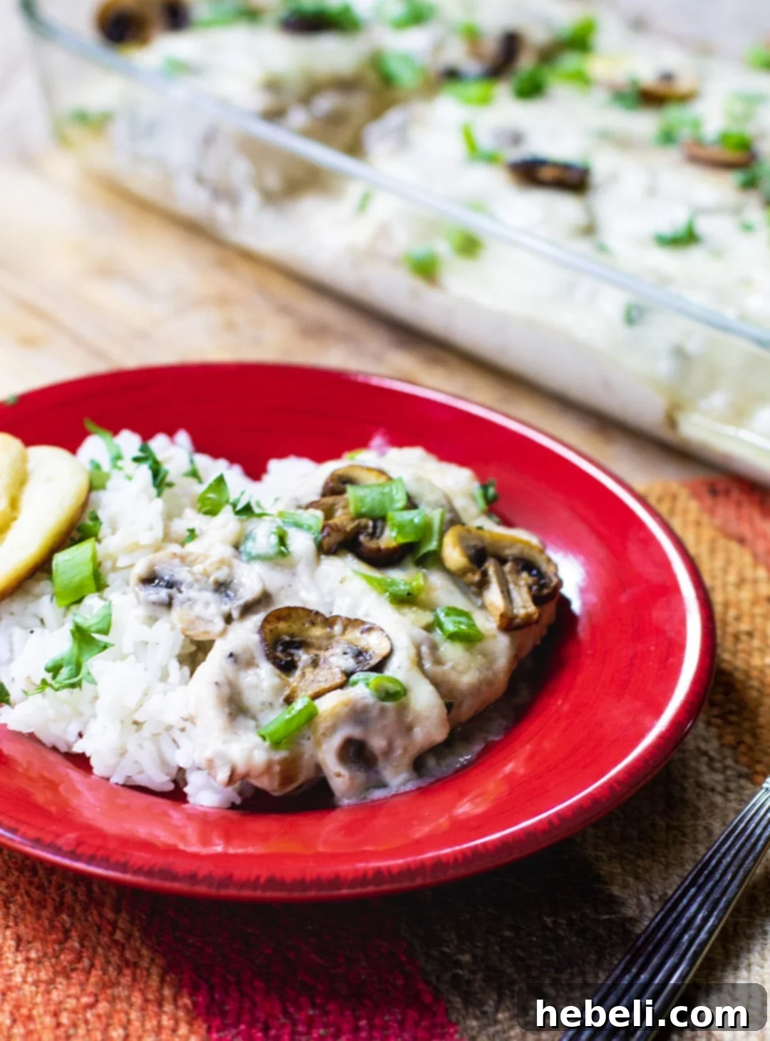A plate of Sherried Chicken with Mushrooms served with white rice, a complete and satisfying meal.