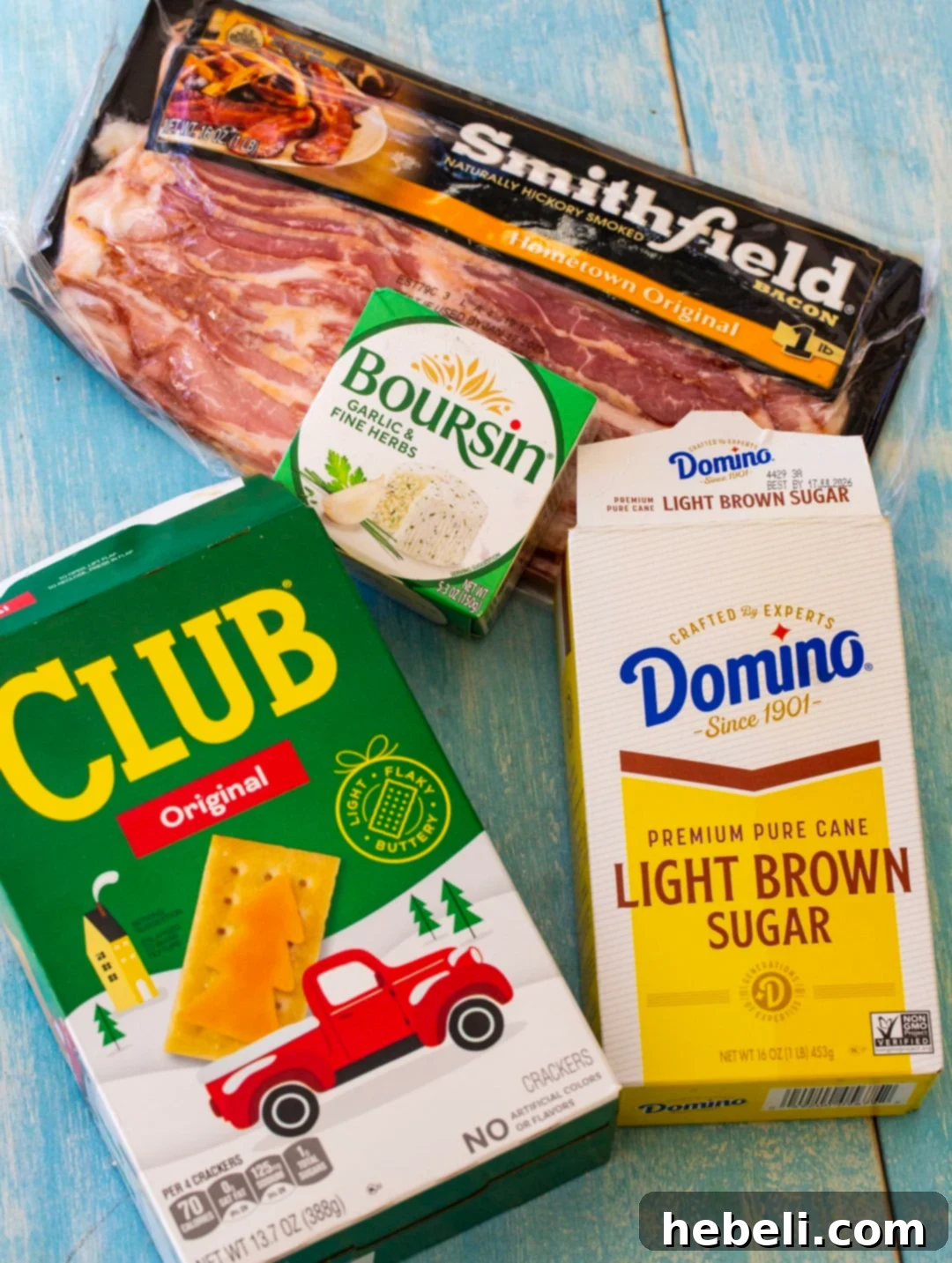 Bacon Boursin Cracker Bites 4 A collection of fresh ingredients for Boursin Bacon Crackers laid out: crispy Club crackers, creamy Boursin cheese, slices of bacon, light brown sugar, and a vibrant dash of cayenne pepper.