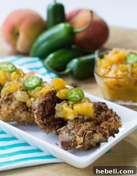 Pecan-Crusted Pork Medallions with peach chutney, and jalapenos in background.
