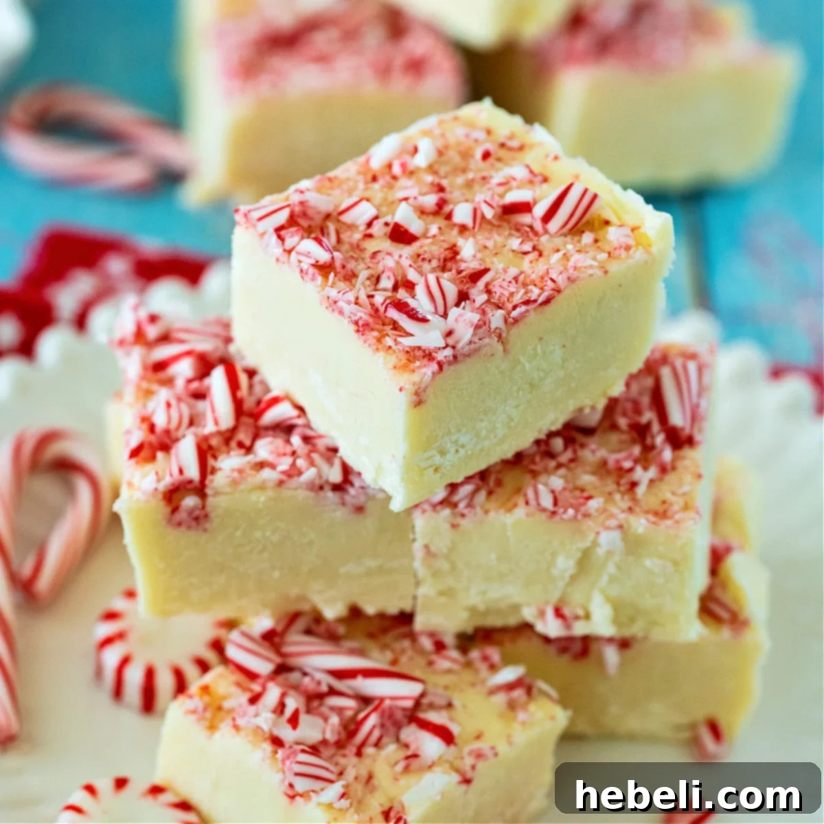 Peppermint Cloud Fudge 2 Stacked squares of creamy Peppermint White Chocolate Fudge, perfect for holiday gifts and dessert trays.