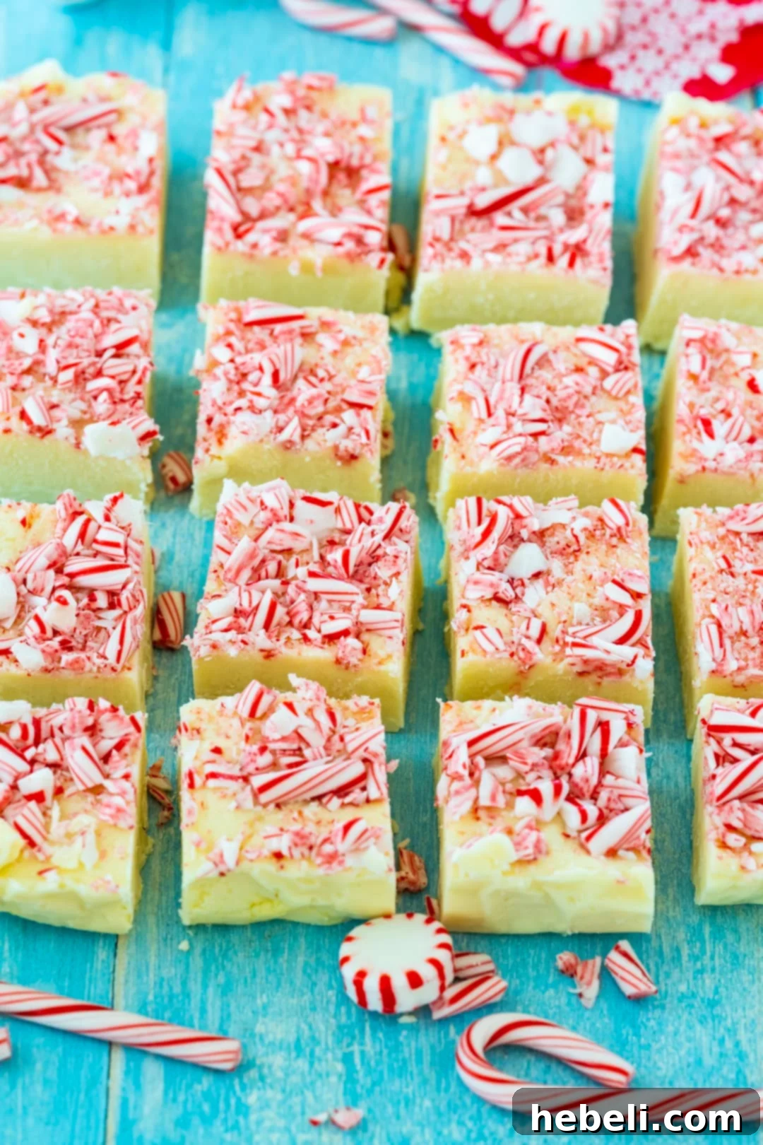 Peppermint Cloud Fudge 3 Perfectly cut squares of Peppermint White Chocolate Fudge adorned with crushed candy canes, ready to be served or gifted.