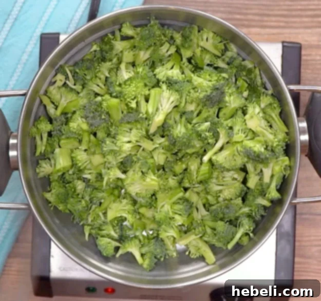 Steamed broccoli florets, chopped into bite-sized pieces, ready for mixing.