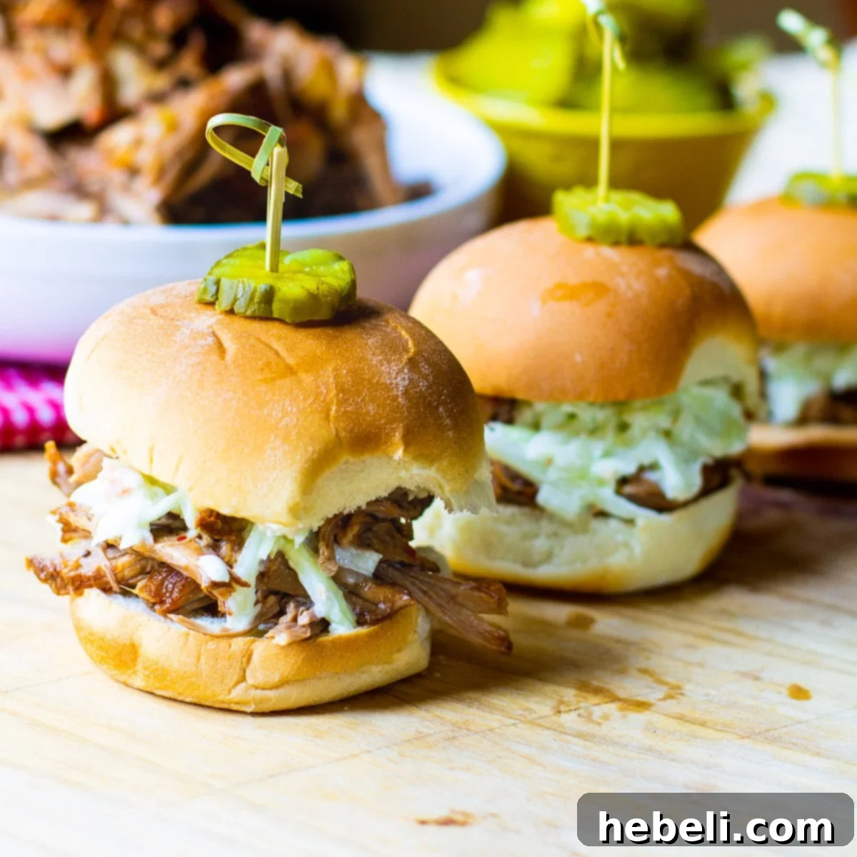 Slow Cooker Carolina-Style Pulled Pork served on slider buns with creamy coleslaw.