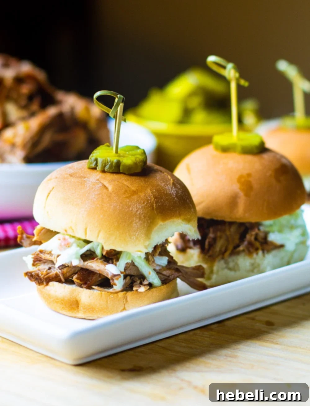 Carolina-Style Pulled Pork served on slider buns with a generous dollop of coleslaw.