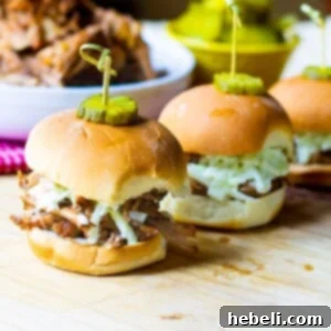 Slow Cooker Carolina-Style Pulled Pork on slider buns with slaw.