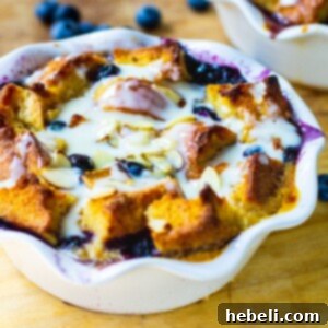 A focused shot of Blueberry White Chocolate Bread Pudding in a white ramekin, featured as the primary recipe image.