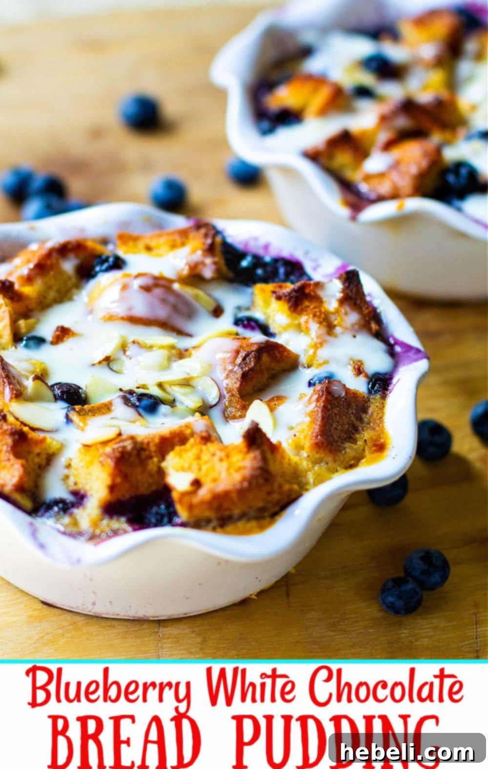 Close-up of fresh blueberries, dried blueberries, and white chocolate chunks on a wooden board, ready to be incorporated into the bread pudding.