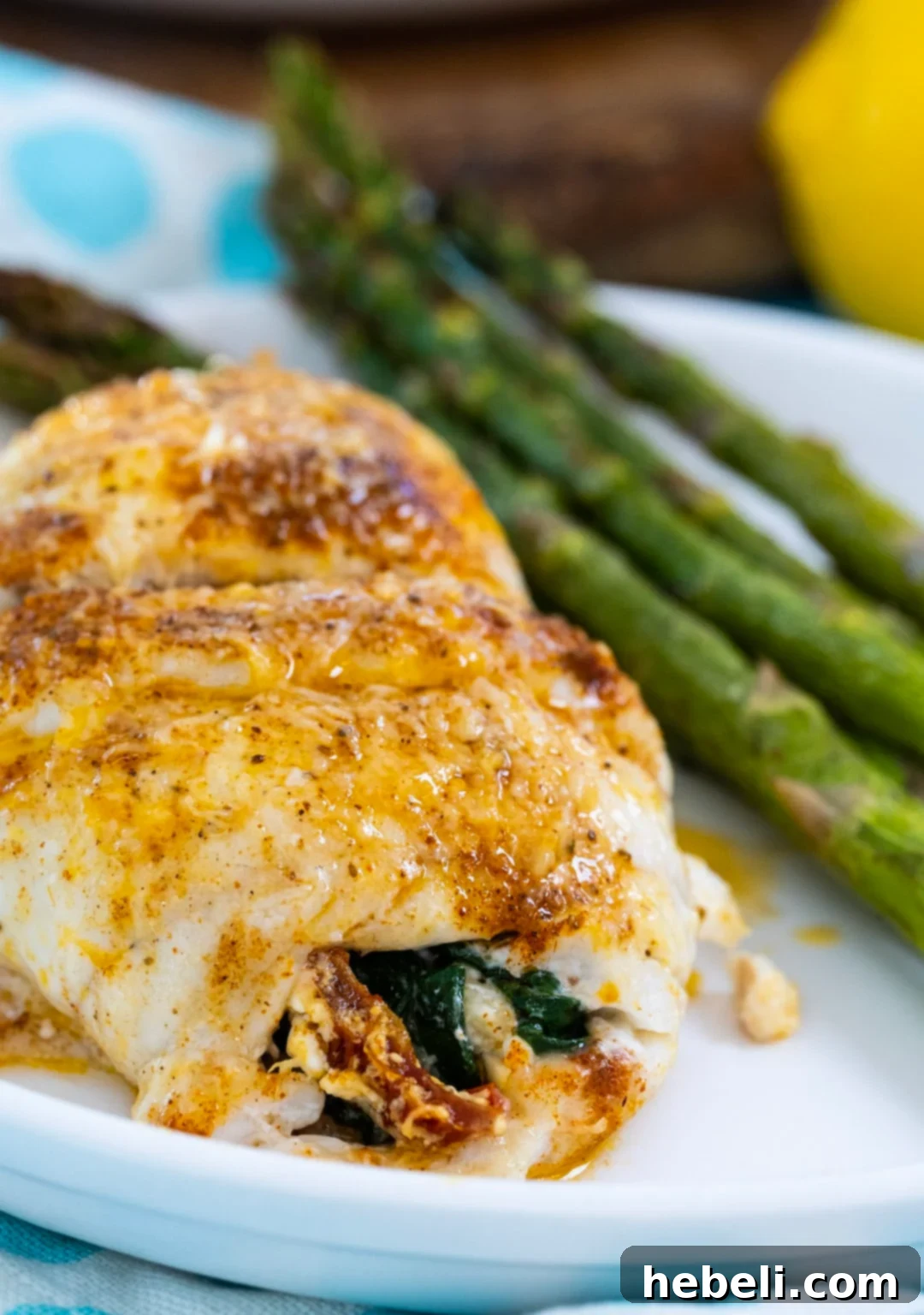 Flounder Fillets Stuffed with Creamy Spinach 3 Stuffed Flounder with spinach on a plate with asparagus, ready to be served.
