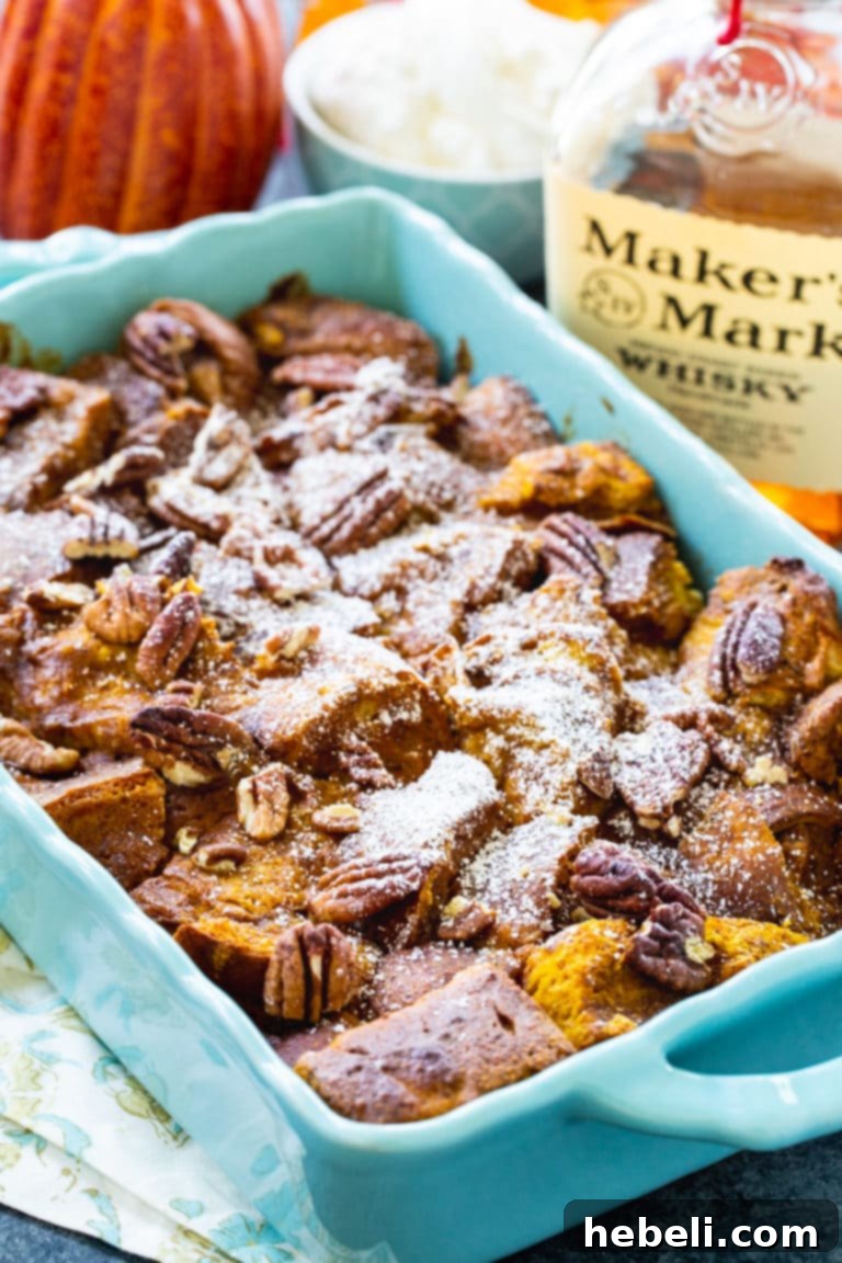 Spiced Pumpkin Bread Pudding with Bourbon Cream 3 Close-up shot of Pumpkin Bread Pudding with Bourbon Whipped Cream, showcasing the rich texture and spices.