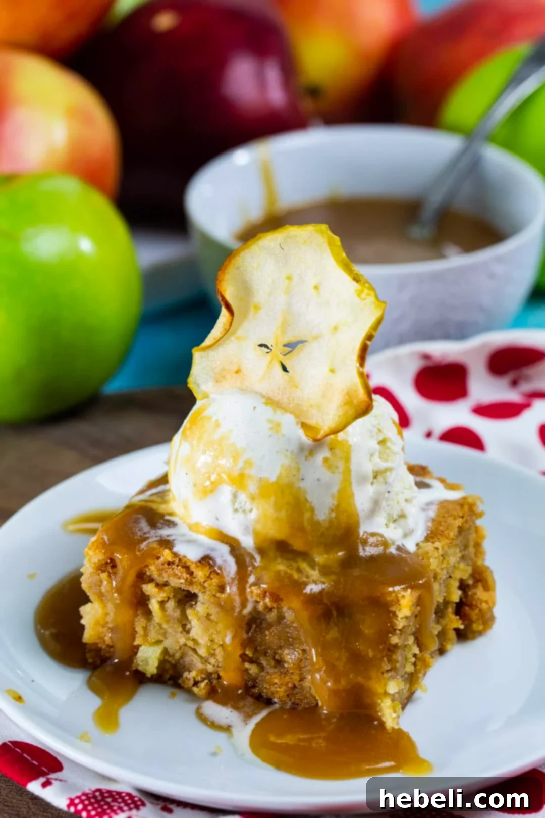 A single Butterscotch Apple Bar served on a plate, generously topped with vanilla ice cream and a luscious caramel sauce.