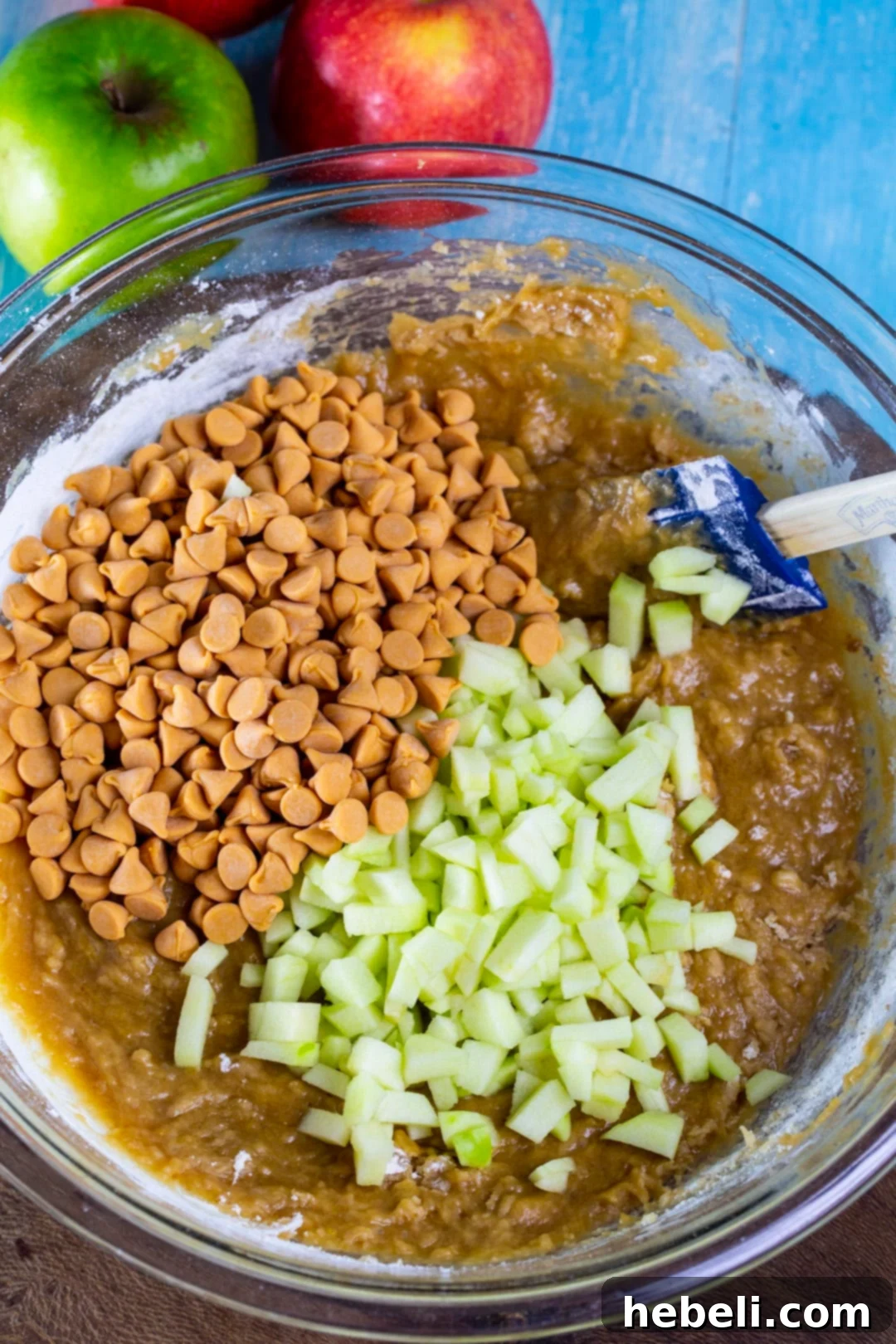 Mixing bowl with butterscotch apple bar batter, diced apples, and butterscotch chips.