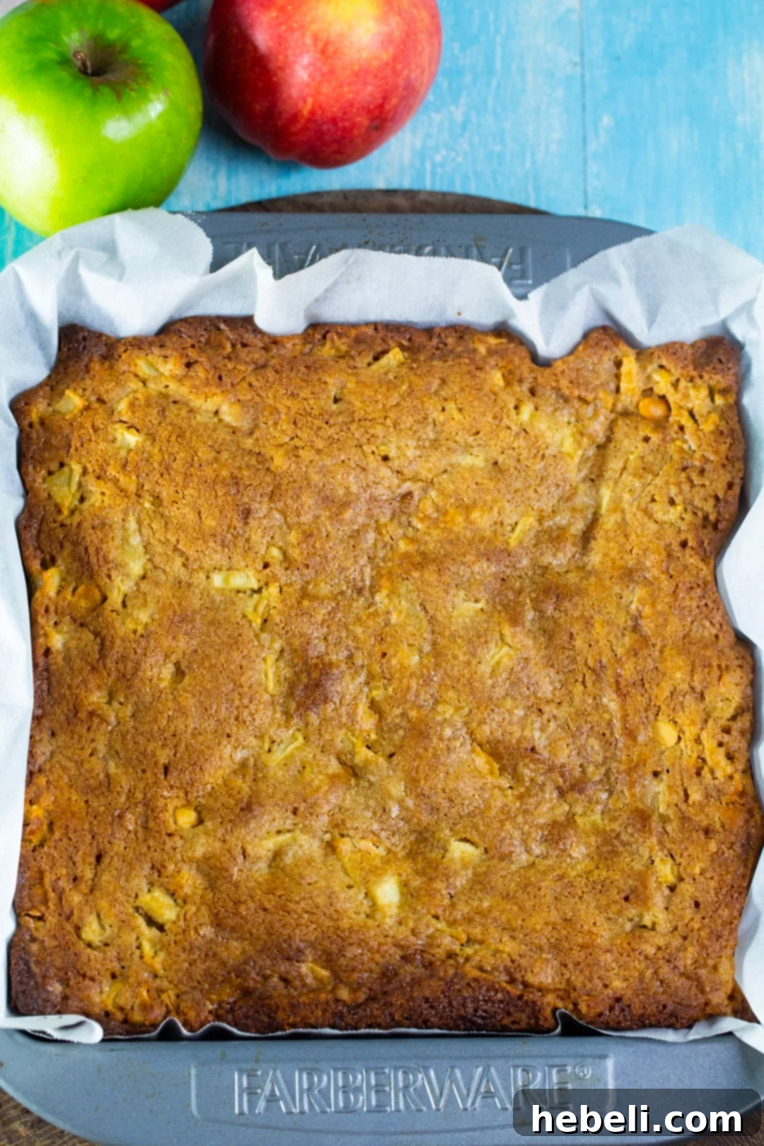 Freshly baked butterscotch apple bars cooling in a baking dish.
