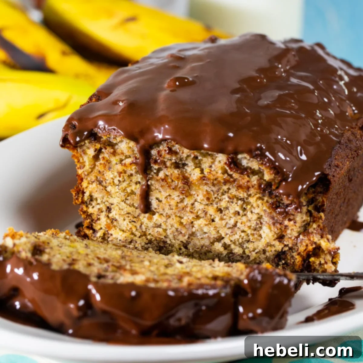 Decadent Chocolate Glazed Banana Bread 2 Banana Bread with Chocolate Glaze with a slice cut, showcasing its moist texture and shiny topping.
