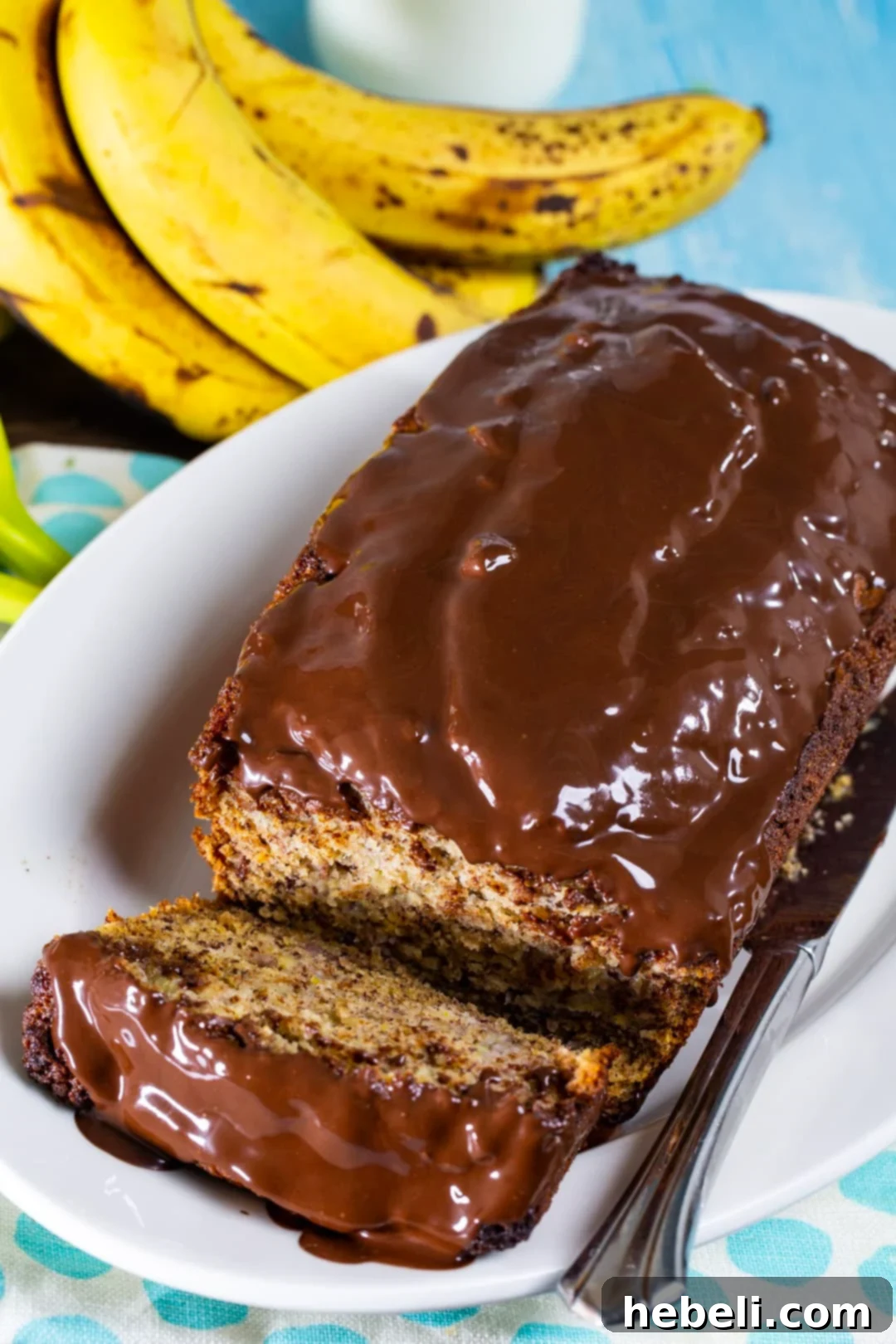 Decadent Chocolate Glazed Banana Bread 4 Banana Bread with Chocolate Glaze on a serving plate, close-up view.