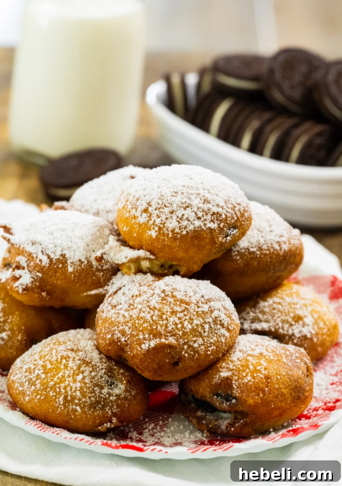 Oreo Fritters 3 Close-up of freshly fried Oreos on a plate, showcasing their golden-brown, puffed batter.