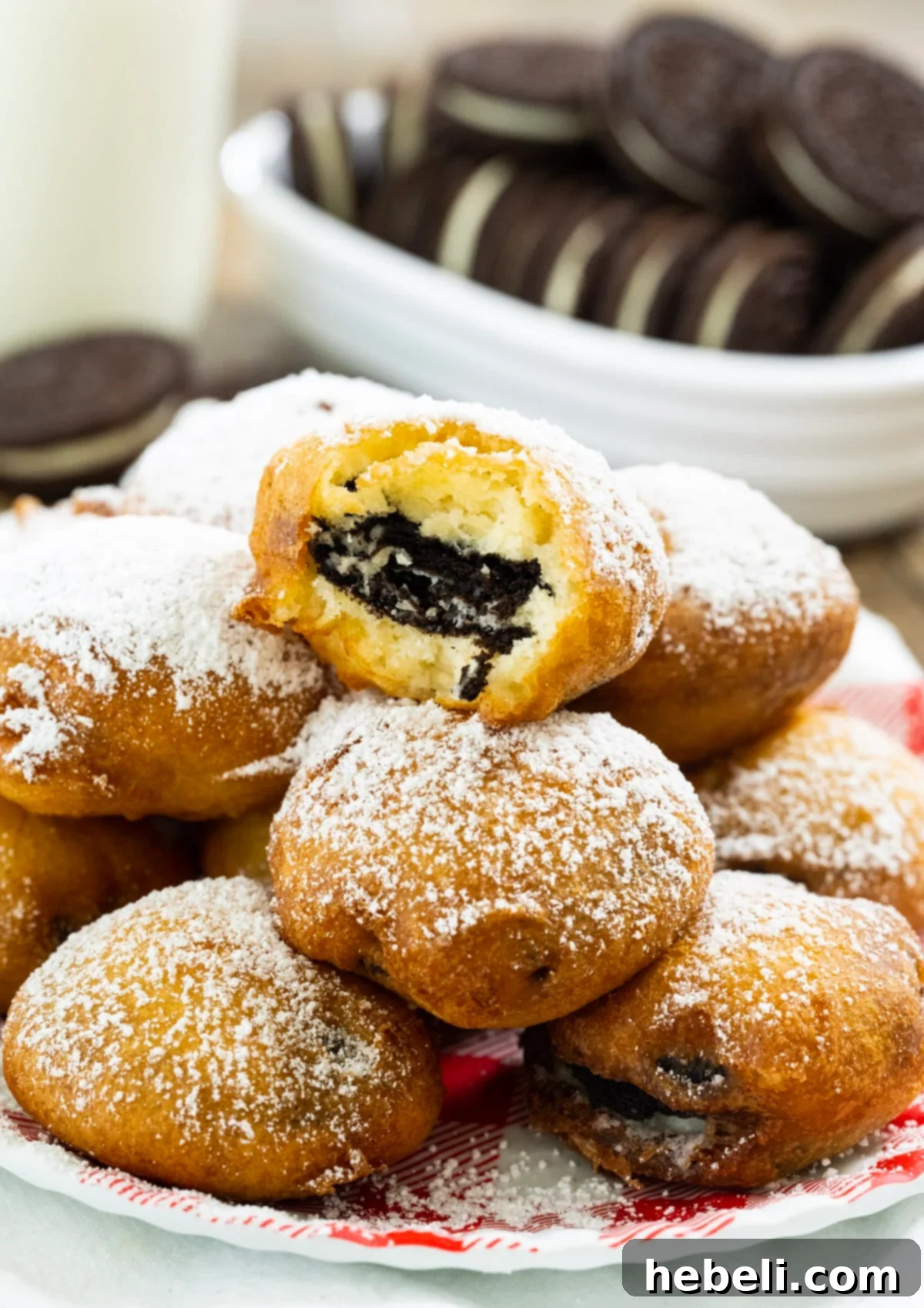 Oreo Fritters 4 A deep-fried Oreo with a bite taken out, revealing the soft, melted cookie inside.