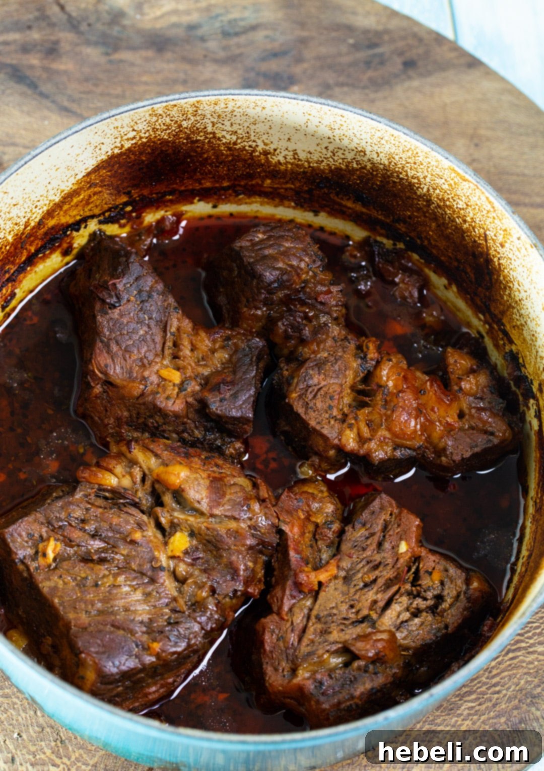 Perfectly cooked and shredded chipotle beef, glistening with sauce and ready to be served, showcasing its tender texture.