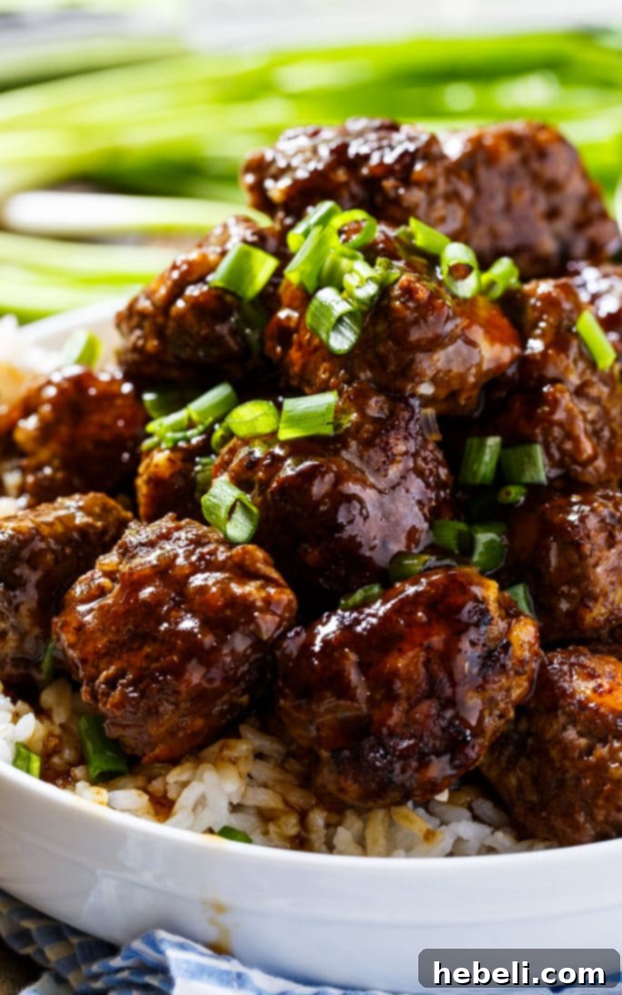 Fiery Apple Glaze Meatballs 4 A large bowl brimming with spicy apple-glazed meatballs, showing off their rich color and succulent texture, perfect for sharing.