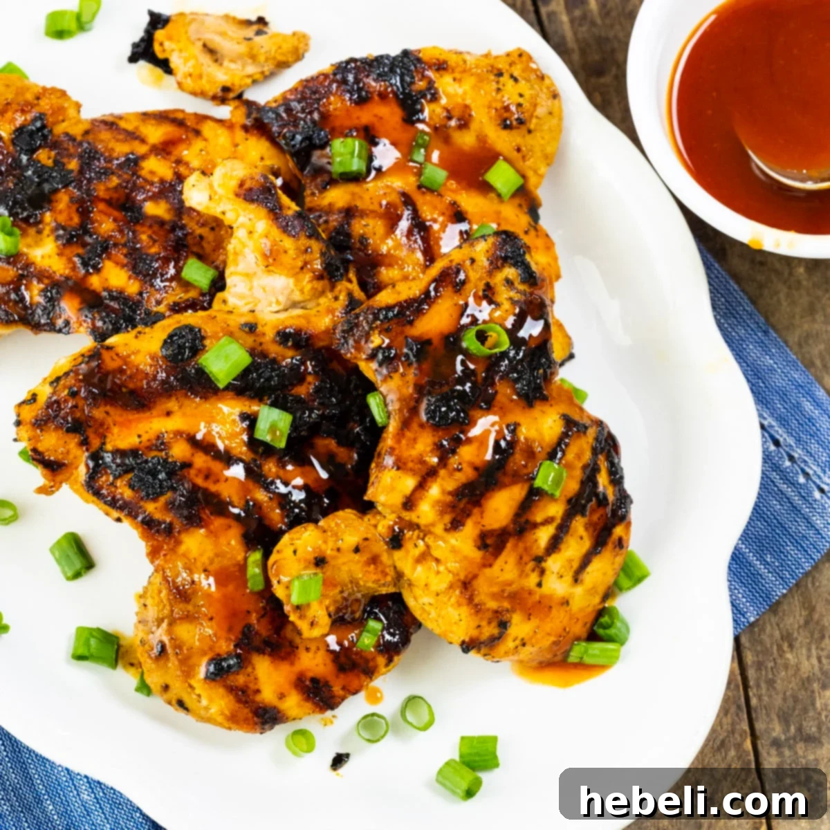 Buffalo Honey Grilled Chicken Thighs on a serving platter, showcasing their golden-brown, glazed exterior.
