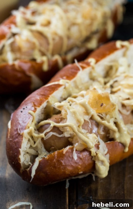 Slow Simmered Beer Brats 4 Slow Cooker Beer Brats in hoagie rolls topped with sauerkraut and drizzled with mustard.