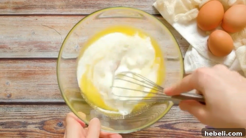 Fluffy Buttermilk Pancakes 4 A bowl with whisked wet ingredients: egg, melted butter, and buttermilk.