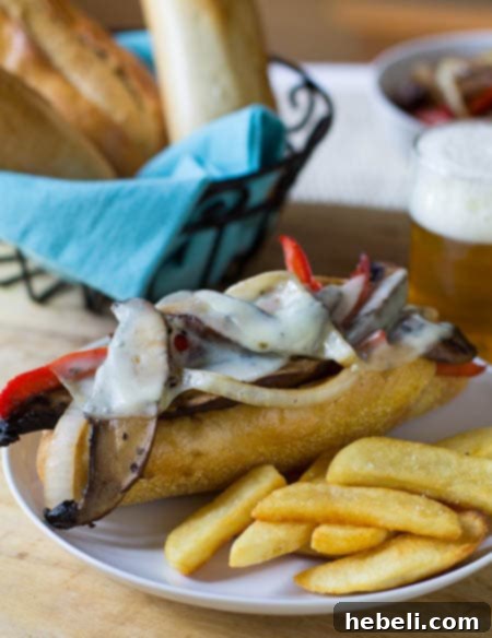 Portobello Cheesesteak Sandwiches 2 Portobello Cheesesteak on a plate with steak fries.