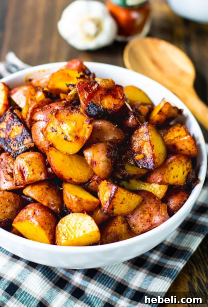 Close-up of golden-brown Paprika Potatoes served in a white bowl, ready to eat.