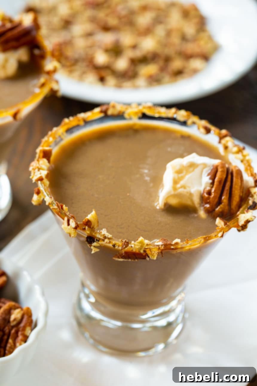 The Pecan Pie Universe 11 An elegant Pecan Pie Martini, garnished with caramel sauce and crushed pecans on the rim, ready for a festive sip.