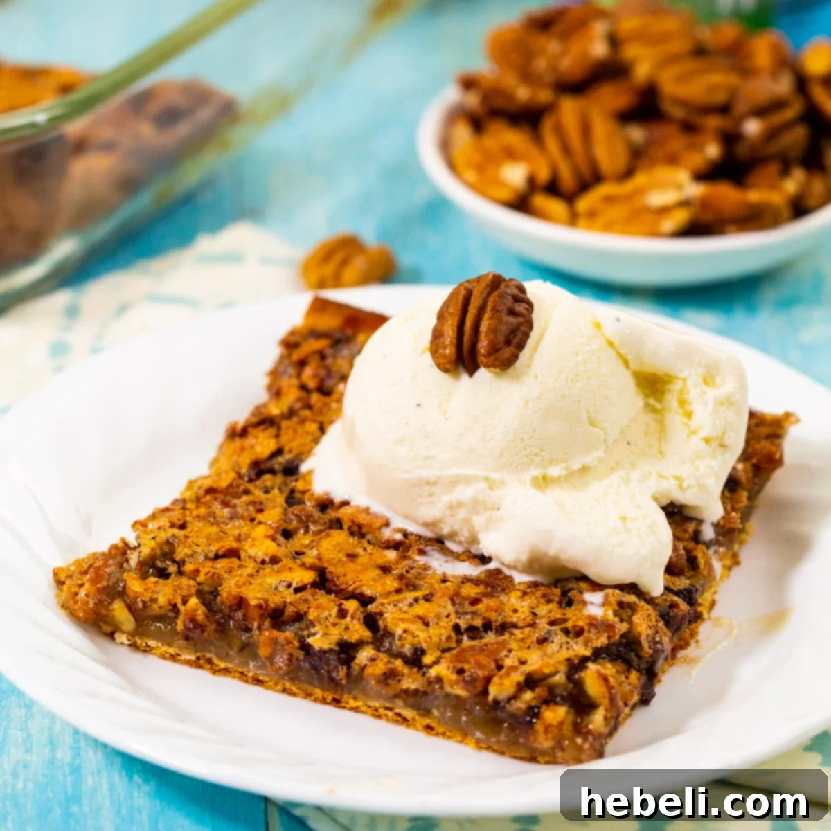 The Pecan Pie Universe 19 Easy-to-make Crescent Pecan Pie Bars, featuring a flaky crust and crunchy pecan topping.