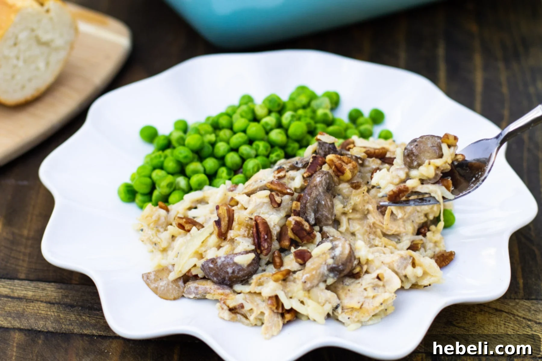 A fork lifting a delicious, creamy bite of Chicken, Rice, and Mushroom Casserole, perfectly illustrating its appetizing texture and appealing warmth.