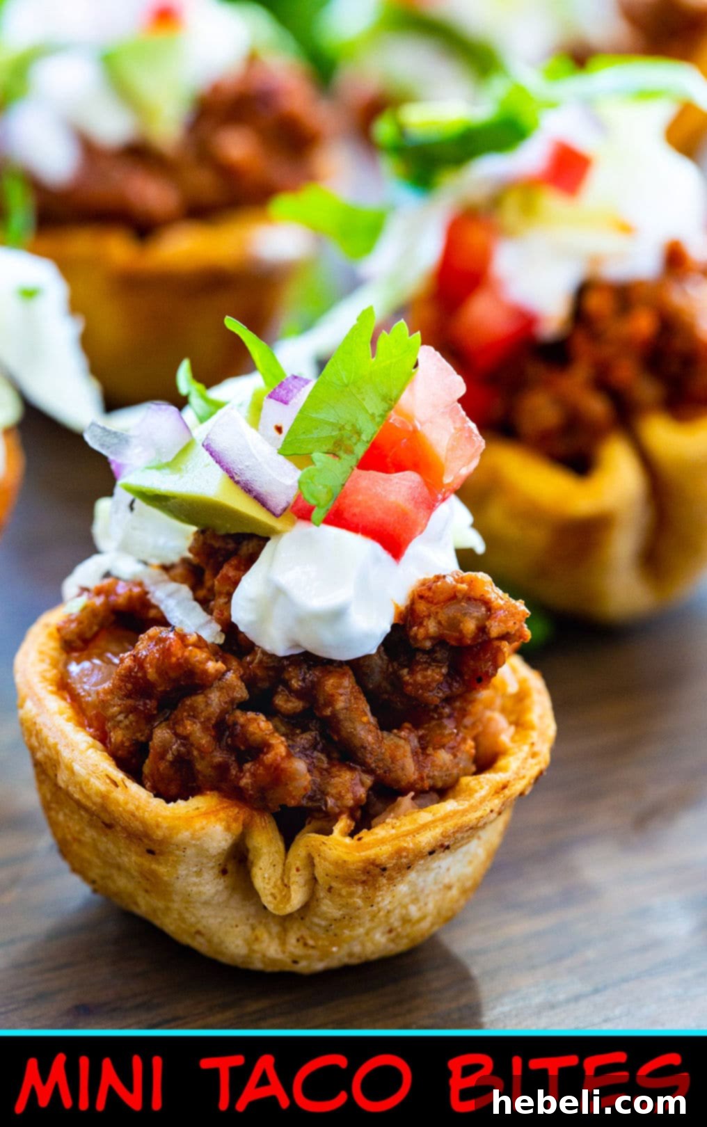Close-up detailed view of a single Mini Taco Bite, showing its various layers and fresh toppings.