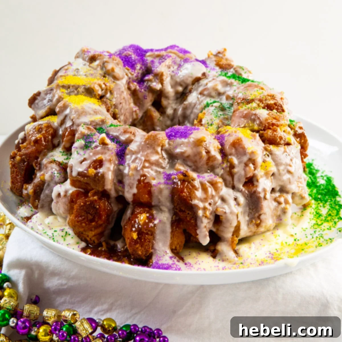 Mardi Gras Party Pull-Apart Bread 2 Mardi Gras Monkey Bread on a serving plate, adorned with festive sprinkles and ready to be enjoyed.