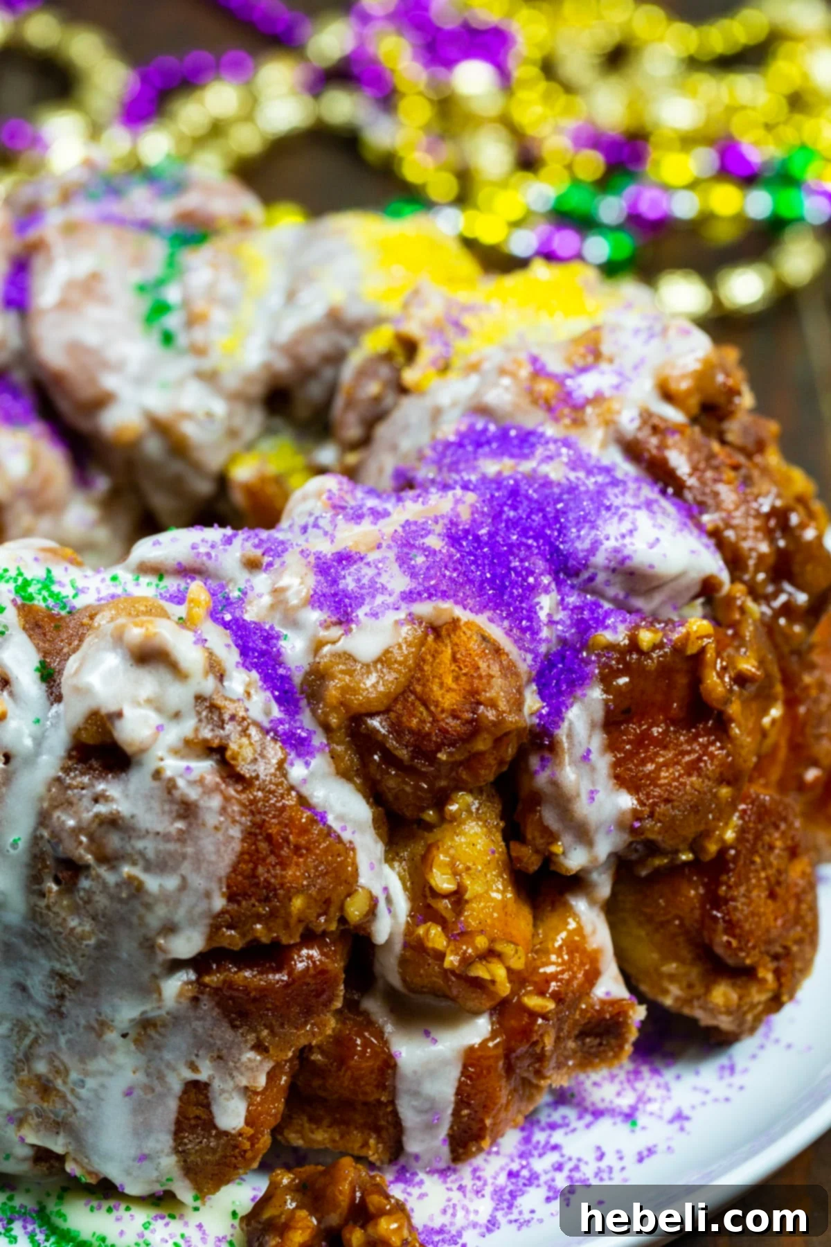 Mardi Gras Party Pull-Apart Bread 4 Close-up of a slice of Mardi Gras Monkey Bread, showcasing its irresistible gooey texture and vibrant colorful sprinkles.