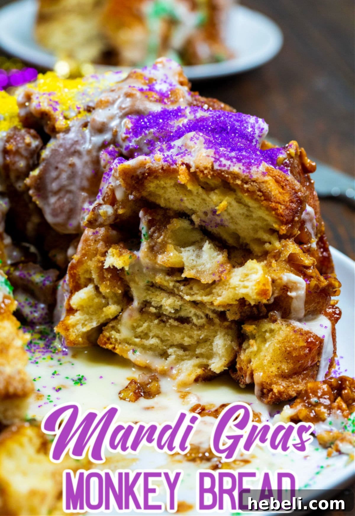 Mardi Gras Party Pull-Apart Bread 5 A large, tempting piece of Mardi Gras Monkey Bread has been removed from the Bundt cake, revealing its deliciously layered and sticky interior.