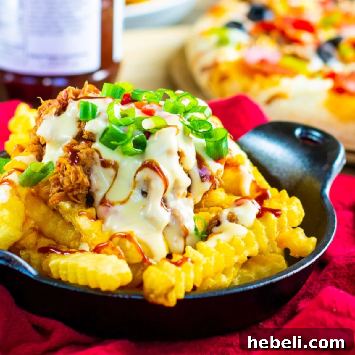 Southern Comfort Cheese Fries 2 Southern Cheese Fries covered with pulled pork and pimento cheese sauce, garnished with fresh green onions.