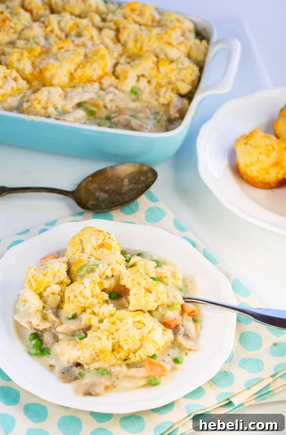 A serving of Chicken Cobbler on a plate, showing the creamy filling and biscuit topping.